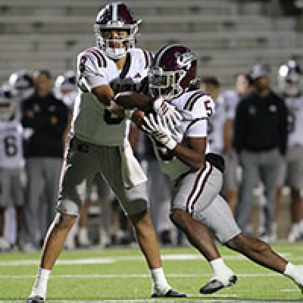 QB Chris Martinez hands the ball to Wenderius Jones in a game last year. Chris McGathey Photo