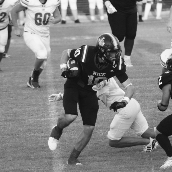 Brody Lawhon (10) heads upfield thanks to a Hugo Hernandez (2) block. Courtesy Photo/Rice Yearbook Staff