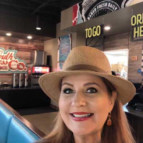 Mayor Angie Juenemann, seated in a local eatery, assures Ennisites they will pull through the present national emergency by working together. “Please continue to support your neighbors,” she said. “We are all in this and we will prevail.”