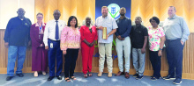 Katrinia Roberson (in red, left of center) received an award (held by David Espedal) for financial excellence. Courtesy Photo/City of Ennis